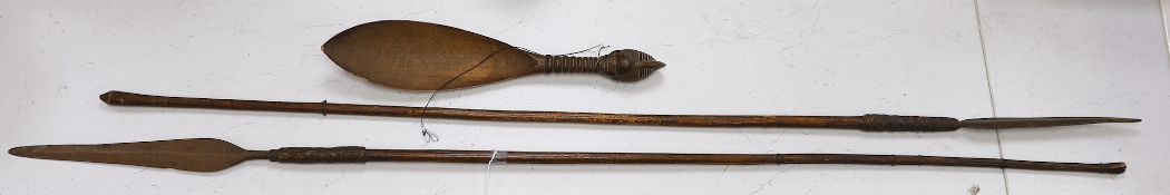Two African throwing spears and a carved spoon with figural handle, longest spear 132cm