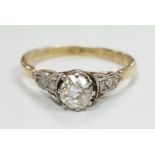 An 18ct and single stone diamond set ring, with diamond set shoulders, size N/O, gross weight 2.2