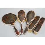 A 1940's silver and tortoiseshell mounted five piece mirror and brush set.