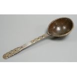 An 18th Russian white and parcel gilt metal ladle, the handle with a niello inlay and a coconut