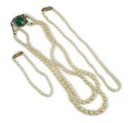 A twin strand graduated cultured pearl necklace, with white metal and two colour paste set clasp,