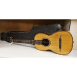 A parlour guitar with hard case. Ivory submission reference: J3WBGCHD