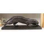 A bronze figure of a leopard, on black marble base, 67cm wide, 22cm high