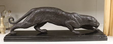 A bronze figure of a leopard, on black marble base, 67cm wide, 22cm high