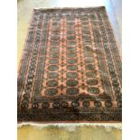 A Bokhara peach ground rug, 190 x 124cm