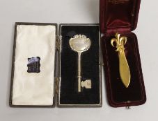 A silver presentation key and gilt metal French tie pin, both cased