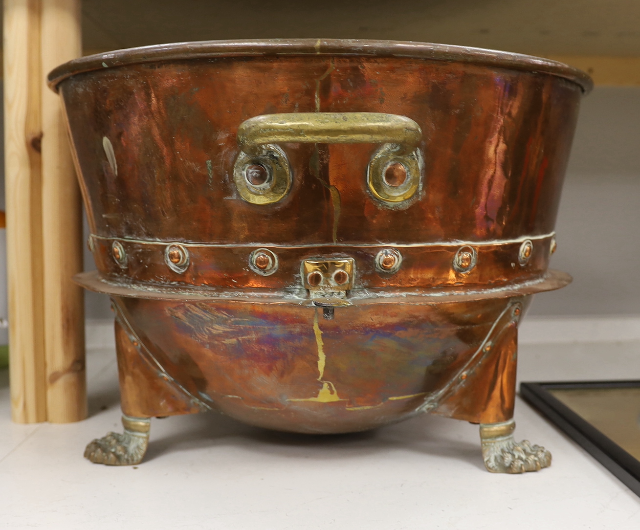 A large copper and brass two handled pail, raised on lion paw supports, 60cm wide including handles - Image 2 of 2