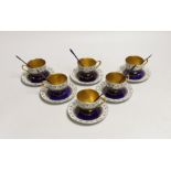 A set of six Royal Worcester porcelain coffee cups and saucers, together with a set of six silver