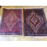 A near pair of Senneh blue ground mats, larger 104 x 77cm