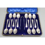 A cased set of twelve Edwardian silver Venetian pattern teaspoons and sugar tongs, A. Beardshaw &
