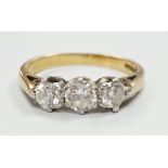 A modern 18ct gold and three stone diamond set ring, size K/L, gross weight 3.6 grams.