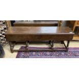 An 18th century style oak drop flap low table, length 130cm, depth 32cm, height 48cm