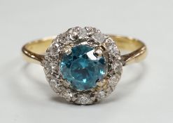 An 18ct & plat, blue zircon and illusion set diamond chip circular cluster ring, size M, gross