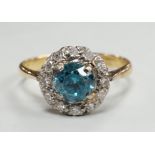 An 18ct & plat, blue zircon and illusion set diamond chip circular cluster ring, size M, gross