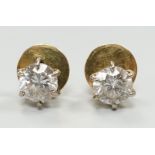 A pair of yellow metal (18ct French poincon mark on discs) and solitaire diamond set ear studs,