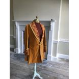 A man's 19th century smoking jacket, mustard velvet, with brocade lapels and cuffs. Ex Royal Opera