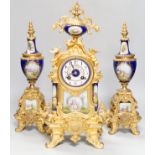 An early 20th century French gilt metal and porcelain set clock garniture, 42cm