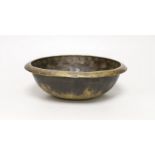 A Tibetan brass singing bowl, Lishui pattern, 23cm diameter