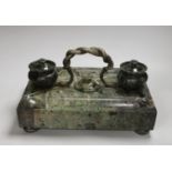 A 19th century green marble inkstand, with brass snake handle, 33cm wide, 23cm deep