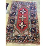 A Caucasian style red ground rug, 186 x 120cm