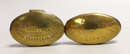 Two early 20th century brass snuff boxes, one with Welsh inscription