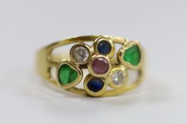 A modern Italian 750 yellow metal and seven stone multi gem collet set ring, size O, gross weight