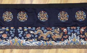 A Chinese long dark blue ground ‘dragon’ altar cloth, late Qing dynasty, polychrome embroidered,