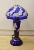 A blue flashed glass mushroom shaped table lamp, with butterfly engraving, 70cm high
