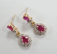 A modern pair of 18k yellow metal, ruby and diamond set pear shaped cluster drop earrings, 20mm,