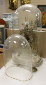 A Victorian skeleton clock and two glass clock domes