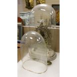 A Victorian skeleton clock and two glass clock domes