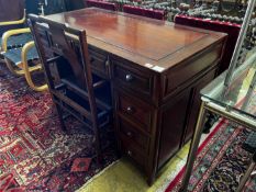 A Chinese hardwood kneehole desk, length 131cm, depth 65cm, height 83cm and elbow chair