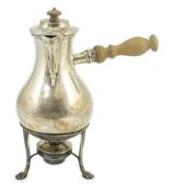 An Edwardian silver baluster chocolate pot, on stand with burner, by Goldsmiths & Silversmiths Co