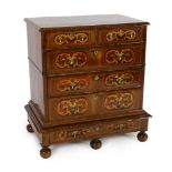 A William III and later walnut and marquetry chest on stand, with quartered top centred with an oval