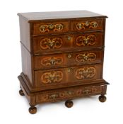 A William III and later walnut and marquetry chest on stand, with quartered top centred with an oval