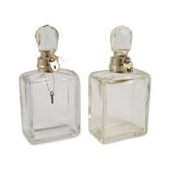 A pair of George V Hukin & Heath silver mounted glass lockable decanters and stoppers, with