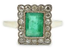 A 1920's 18ct white gold and platinum, emerald and millegrain set diamond rectangular cluster