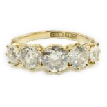 An 18ct gold and graduated five stone diamond set half hoop ring, the total diamond weight