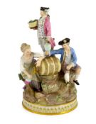 A Meissen group of grape pickers with barrels of wine, 19th century, modelled on a rockwork and tree