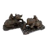 A pair of large Chinese carved hardwood buffalo groups, early 20th century, each well carved with