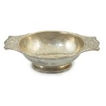 A George V Arts & Crafts planished silver two handled oval bowl by Omar Ramsden, with embossed