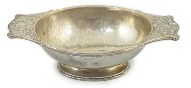 A George V Arts & Crafts planished silver two handled oval bowl by Omar Ramsden, with embossed
