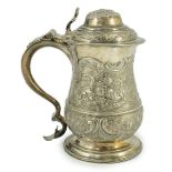 A George II silver baluster tankard, with later embossed decoration, by Robert Albin Cox, with