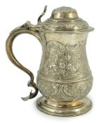 A George II silver baluster tankard, with later embossed decoration, by Robert Albin Cox, with