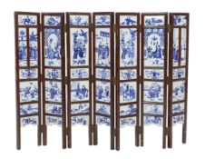 A Chinese blue and white panelled seven-fold low screen, late 19th/early 20th century, the panels