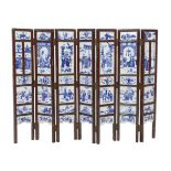 A Chinese blue and white panelled seven-fold low screen, late 19th/early 20th century, the panels