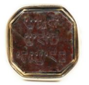 Judaica: A 19th century gold and jasper set ring, the stone carved with Hebrew script, size N, gross