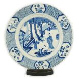 A Chinese blue and white ‘court scene’ dish, Kangxi period, painted with a court official and