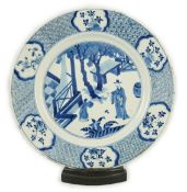 A Chinese blue and white ‘court scene’ dish, Kangxi period, painted with a court official and