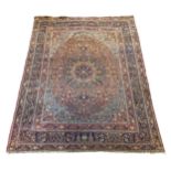 A large Persian blue ground carpet, with central floral medallions radiating outwards to a